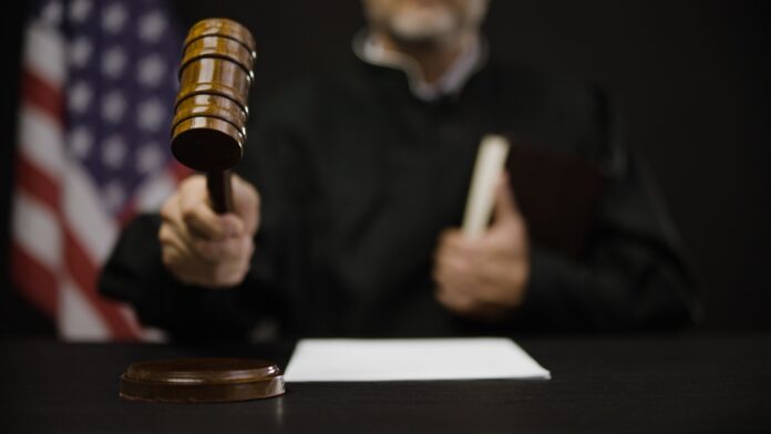 Male,Judge,Hitting,Gavel,,Calling,Court,Members,To,Stand,,United
